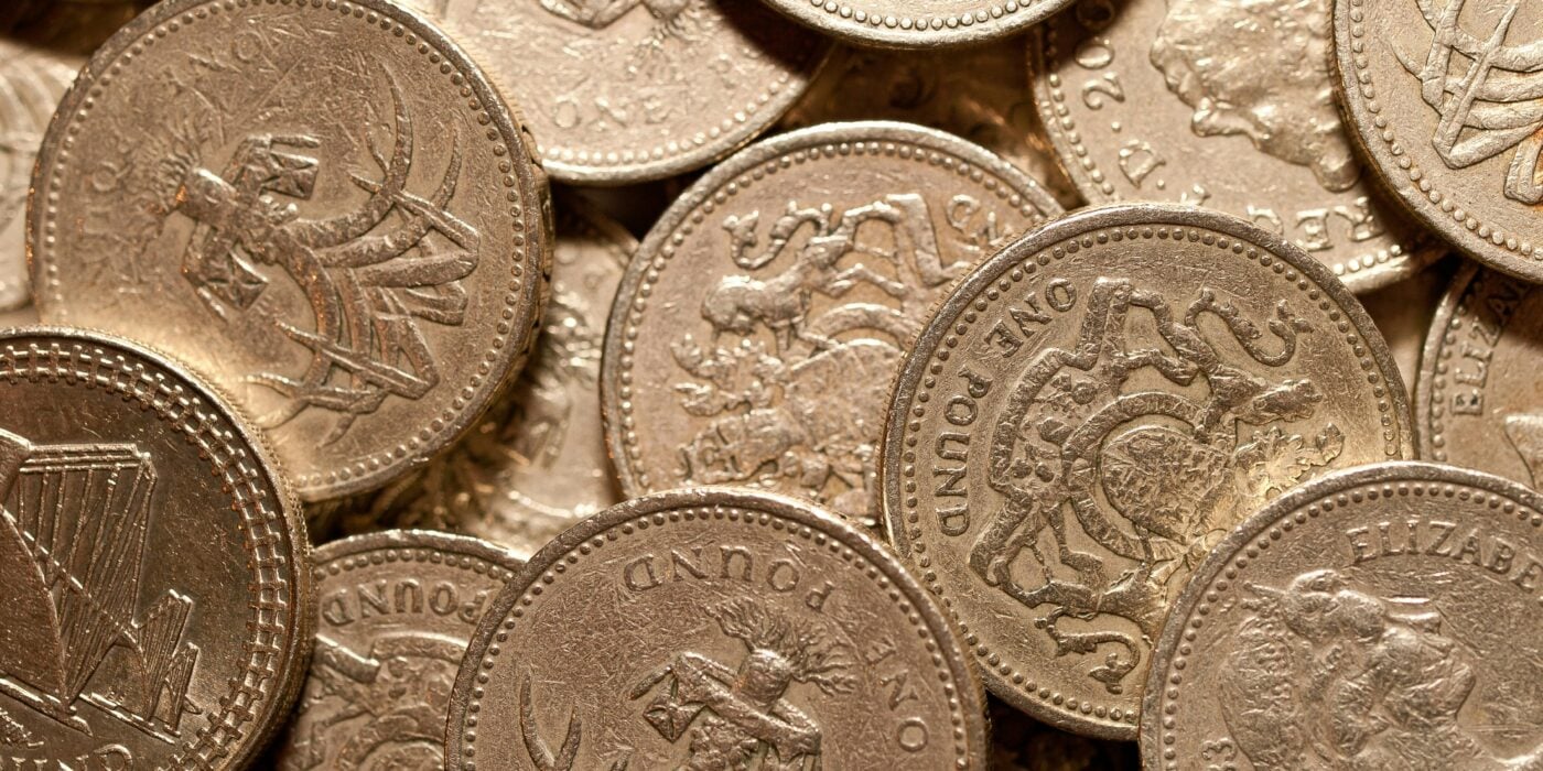 Macro shot of golden British pound coins showcasing intricate designs and details.