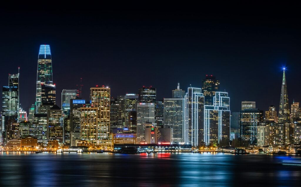 Stunning view of San Francisco&#039;s skyline with illuminated skyscrapers, captured at night.