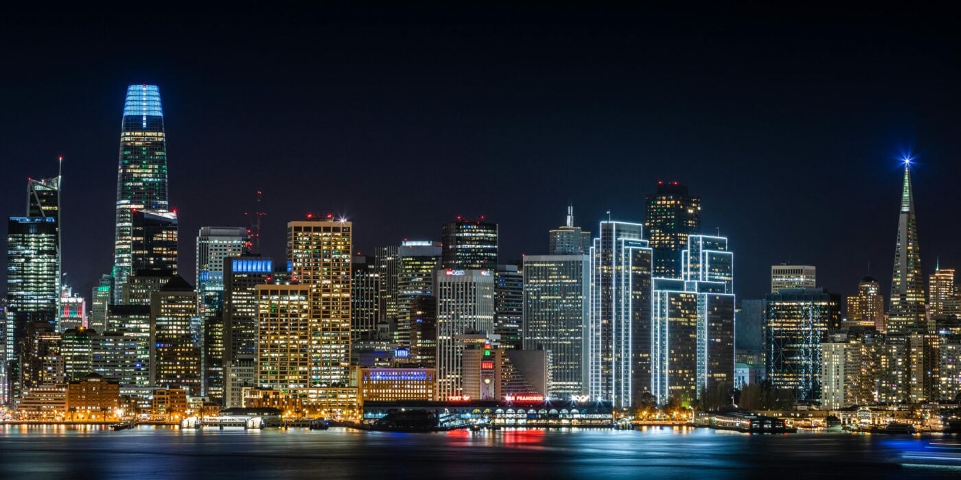 Stunning view of San Francisco's skyline with illuminated skyscrapers, captured at night.