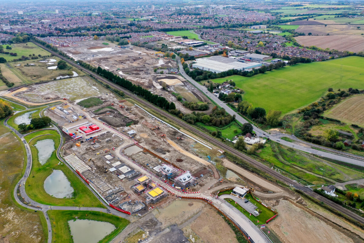 An aerial vie of a building site in its early stages with roadways and machinery on a mud base