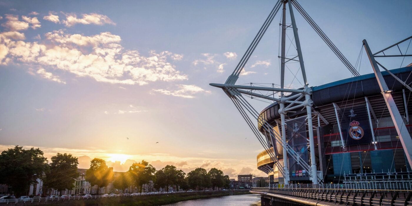 Scenic view of Principality Stadium by River Taff in Cardiff, Wales during sunset.
