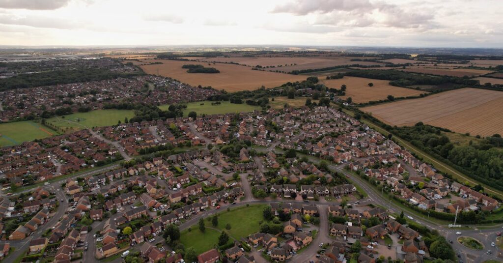 A sprawling residential area in Luton, England, surrounded by fields under a cloudy sky.