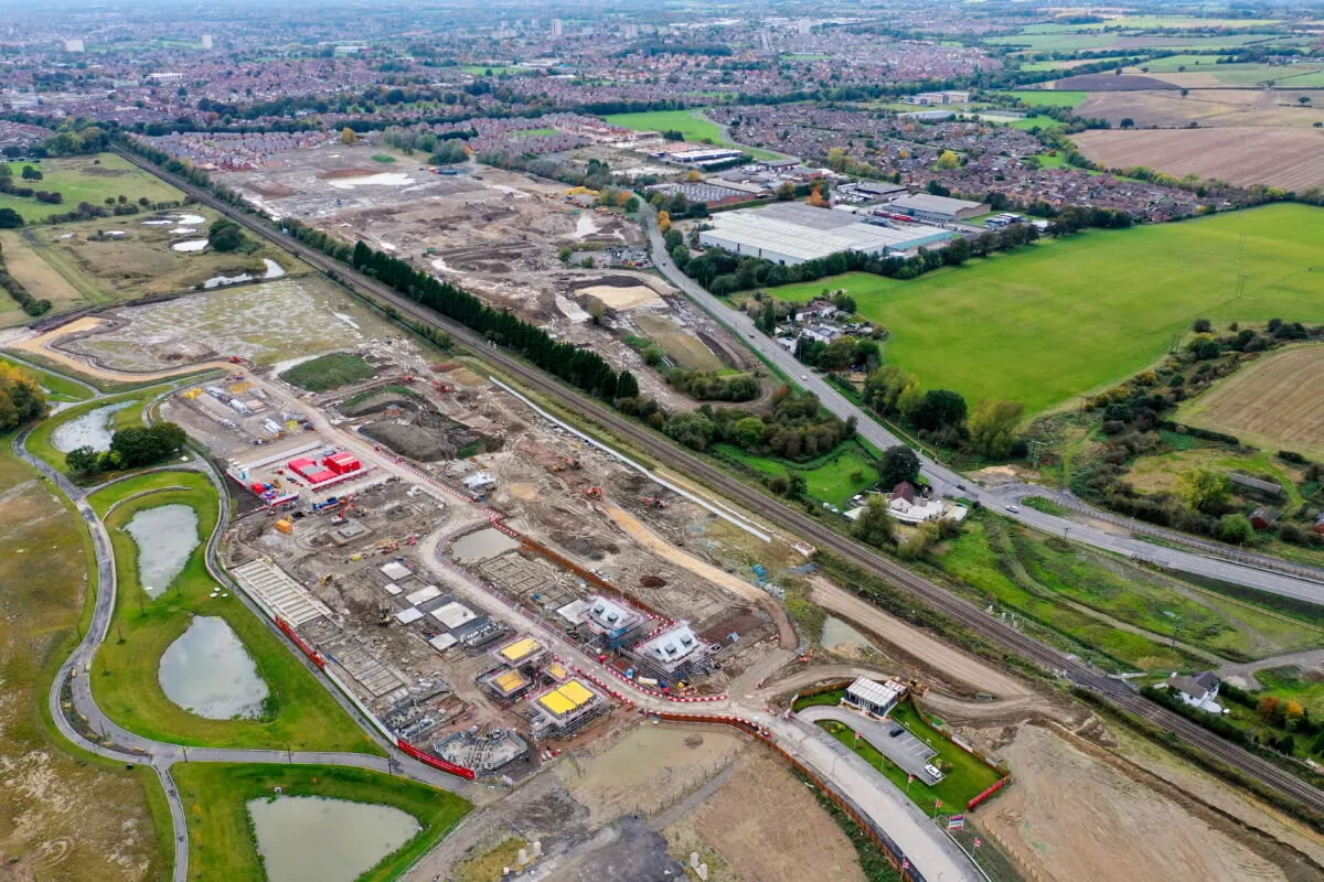 An aerial vie of a building site in its early stages with roadways and machinery on a mud base