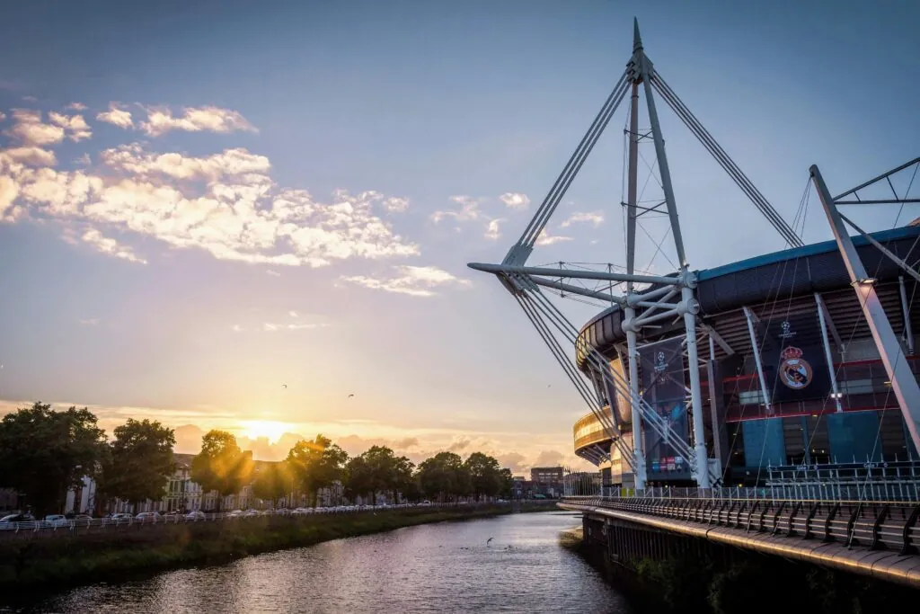 Scenic view of Principality Stadium by River Taff in Cardiff, Wales during sunset.